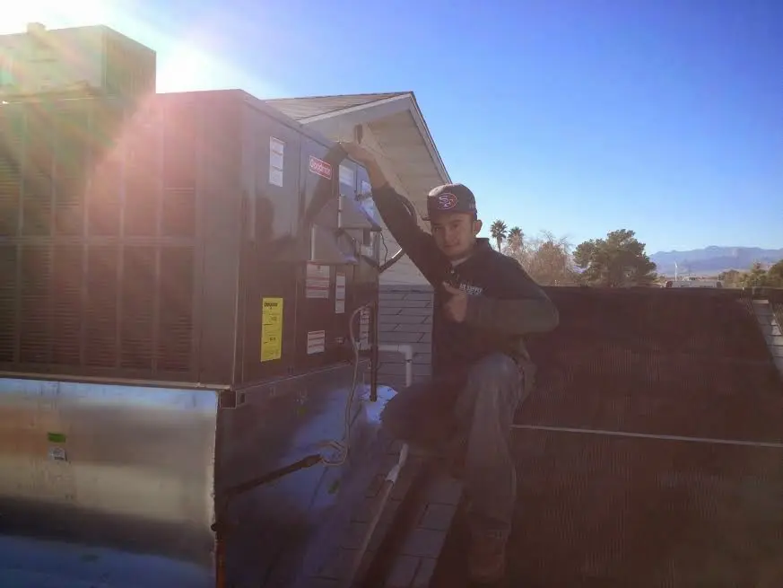 HVAC technician performing HVAC Inspection on a rooftop unit in Normandy Park